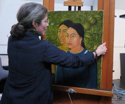 MFA Conservator of Paintings Rhona MacBeth places Frida Kahlo's “Dos Mujeres (Salvadora y Herminia) (1928)” on an easel for display. It was the first painting Kahlo ever sold. (Andrea Shea/WBUR)