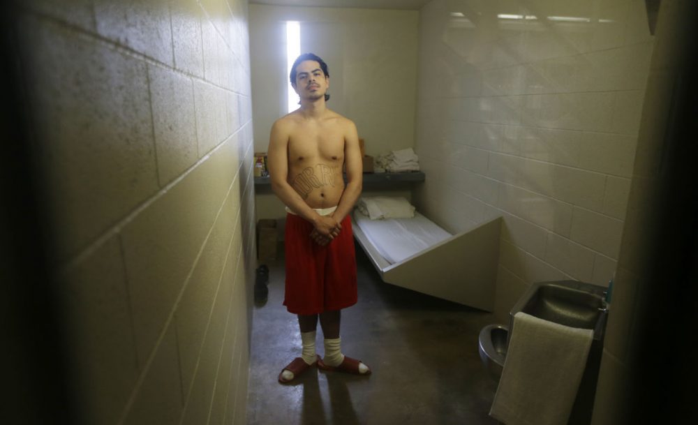 In this Aug. 31, 2015 photo, Josue Torres-Rubio, of Wapato, Wash., who is serving time on charges for robbery, residential burglary and possession of a stolen car, poses for a photo inside his solitary confinement cell at the Washington Corrections Center, in Shelton, Wash. For dozens of maximum custody prisoners at the facility, 23 hours each day is spent alone in a small cell with one hour to walk or run, also alone, in a recreation room with high concrete walls and a metal-grated roof. In the coming weeks, some prisoners in solitary confinement  will have the option of using their hour outside of their cells to watch sunsets, mountains and underwater seascapes on video, with the hope that inmates will be calmer, and guards will have to deal with fewer outbursts or violent interactions. (Ted S. Warren/AP)
