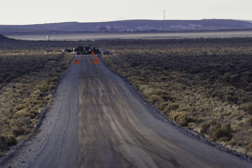 Law enforcement agencies operate a checkpoint on a road as a containment strategy surrounding the Malheur Wildlife Refuge January 27, 2016 near Burns, Oregon. Although leaders of a group that illegally occupied the federal buildings were arrested, many armed occupants still on site have said that they intend to stay despite repeated requests to leave. The iconic wildlife tower of the buildings is visible in the upper left of this photograph. (Rob Kerr/AFP/Getty Images)