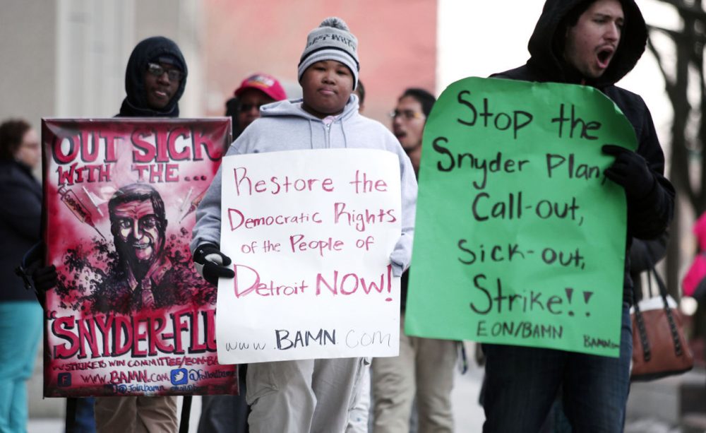 Demonstrators protest a hearing at the State of Michigan Building January 25, 2016 in Detroit, Michigan. The hearing will decide whether or not to order an end to the &quot;sick-out&quot; by Detroit Public School teachers and organizers. One sick-out last week led to the closing of 88 Detroit schools. (Bill Pugliano/Getty Images)