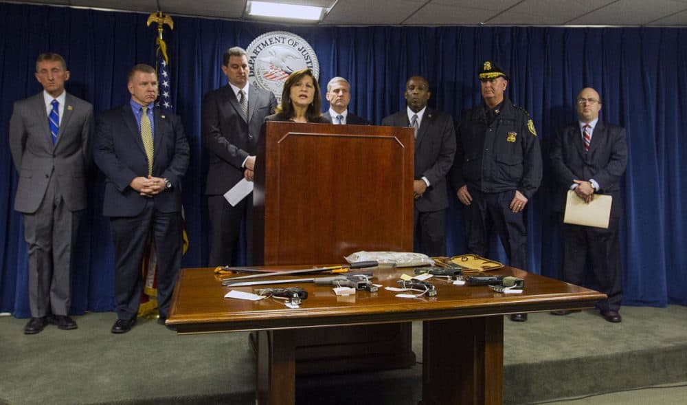 U.S. Attorney Carmen Ortiz, standing among other law enforcement officials, announced Friday the indictment of 56 Boston-area suspects believed to be members of the violent Salvadoran street gang MS-13. (Joe Difazio for WBUR)