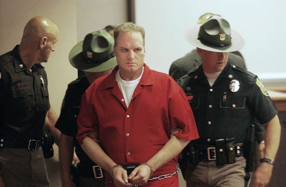 In this 2004 file photo, Gary Lee Sampson, center, is escorted into Hillsborough County Superior Court in Nashua, New Hampshire. (Jim Cole/AP)