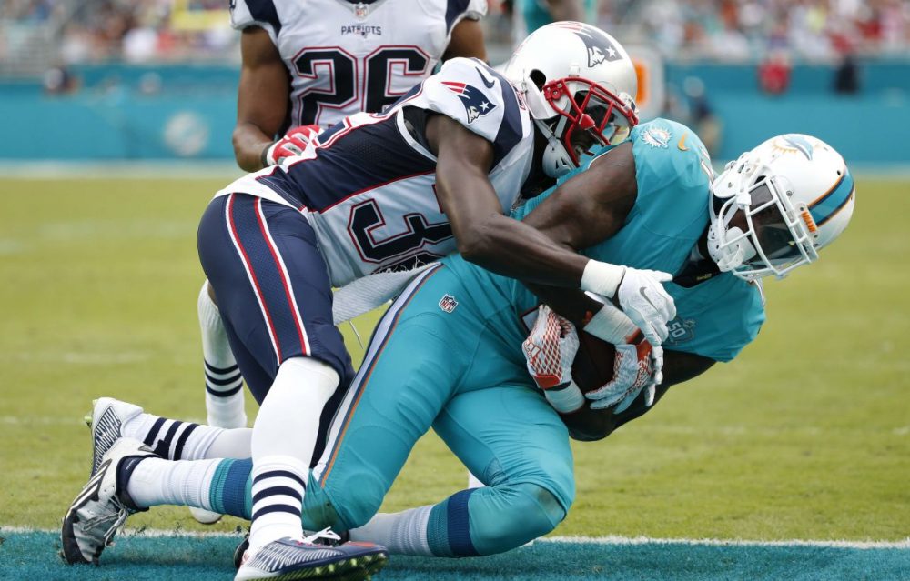 Miami Dolphins wide receiver DeVante Parker (11) scores a touchdown as Patriots free safety Devin McCourty (32) defends during Sunday's game in Miami Gardens, Florida. (Wilfredo Lee/AP)