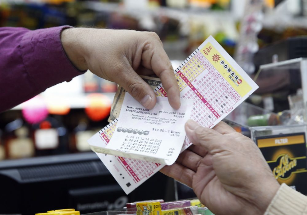 Money and Powerball tickets change hands at Pine Liquors in Fort Washington, Md., Friday, Jan. 8, 2016, for the upcoming Powerball drawing.  (Alex Brandon/AP)