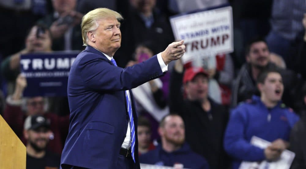 Republican presidential candidate Donald Trump gestures as a protester is removed from the arena during a campaign stop at the Tsongas Center in Lowell on Monday. (Charles Krupa/AP)
