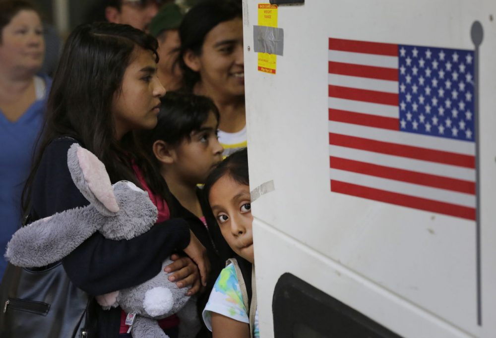 In this July 2015 file photo, immigrants from El Salvador and Guatemala who entered the country illegally board a bus after they were released from a family detention center in Texas. The Department of Homeland Security has recently begun raids to deport people who have illegally entered the U.S. within the last two years and have been issued final orders of removal. (Eric Gay/AP)