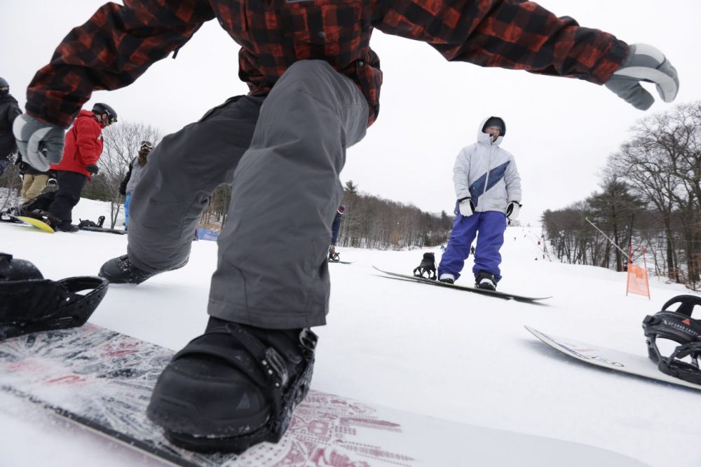 In this 2013 file photo, snowboarders traverse make their way toward a chairlift at Blue Hills Ski Area in Canton. (Steven Senne/AP)