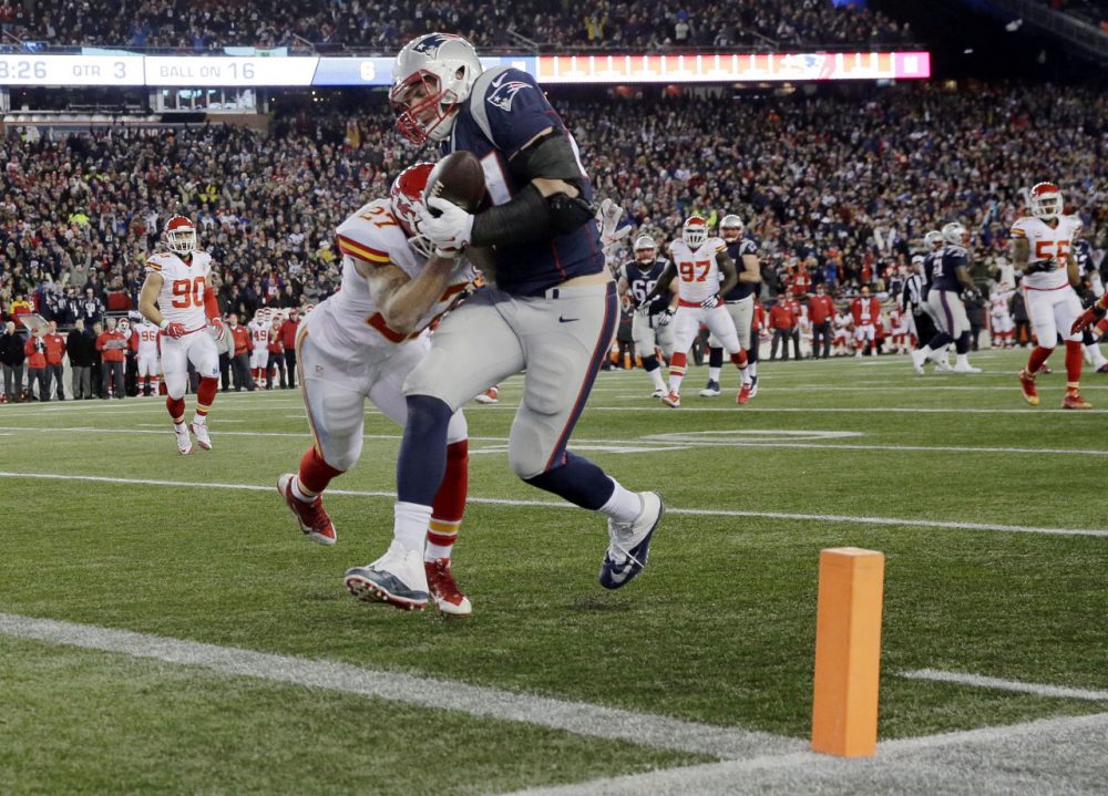 Patriots tight end Rob Gronkowski catches a pass for a touchdown ahead of Chiefs defensive back Tyvon Branch in the divisional playoff on Saturday. (Charles Krupa/AP)