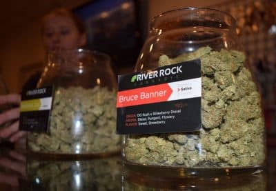 A jar of marijuana buds for sale inside the River Rock dispensary in Denver. New regulations in Massachusetts would allow customers to buy and consume marijuana on the premises, much like at buying a drink at a bar. (Steve Brown/WBUR)