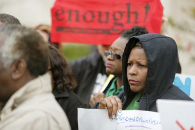 Protesters hold signs at a press conference in front of city hall in North Charleston, S.C., Friday, Jan 8, 2016, in the wake of the release of former North Charleston police officer Michael Slager on bond. Slager was charged with murder in the shooting death of an unarmed black motorist in April 2015. Protesters from Black Lives Matters and the National Action Network listed demands they want meet, with the first being Slager back in jail. (AP Photo/Mic Smith)