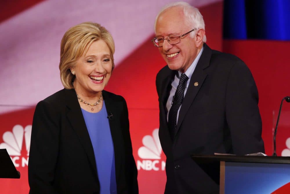 Democratic presidential candidate, Hillary Clinton and Democratic presidential candidate, Sen. Bernie Sanders, I-Vt. smile during a break of the NBC, YouTube Democratic presidential debate at the Gaillard Center, Sunday, Jan. 17, 2016, in Charleston, S.C. (AP Photo/Mic Smith)