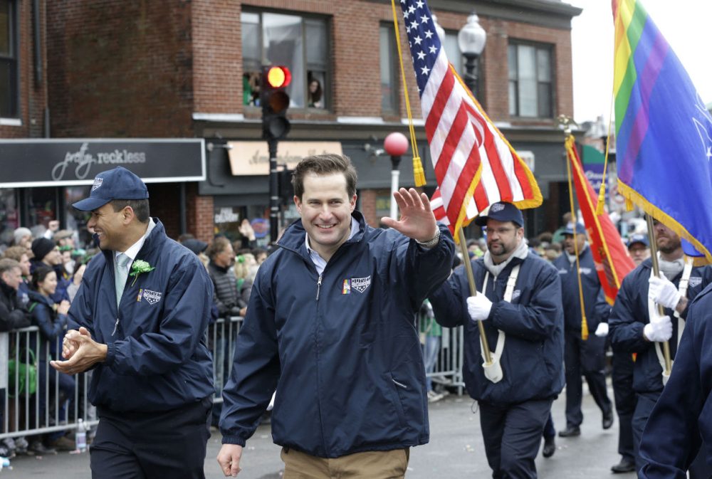 U.S. Rep. Seth Moulton, D-Mass., center, waves while marching with members of OutVets, a group of gay military veterans, as they participate in the St. Patrick's Day parade, Sunday, March 15, 2015, in Boston's South Boston neighborhood. Until now, gay rights groups have been barred by the South Boston Allied War Veterans Council from marching in the parade, which draws as many as a million spectators each year. (AP Photo/Steven Senne)