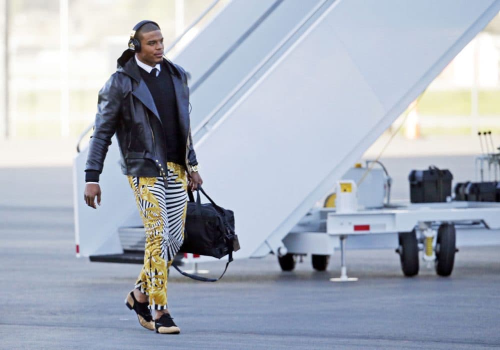 In this Jan. 31, 2016 photo, Carolina Panthers quarterback Cam Newton gets off the plane at the Mineta San Jose International Airport in San Jose, Calif.  The Panthers play the Denver Broncos on Sunday, Feb. 7, 2015, in Super Bowl 50. Newton was snapped Sunday in the zebra stripe, gold swirl rocker pants immediately setting social media and TV talking heads into a frenzy. (Charlie Riedel/AP)