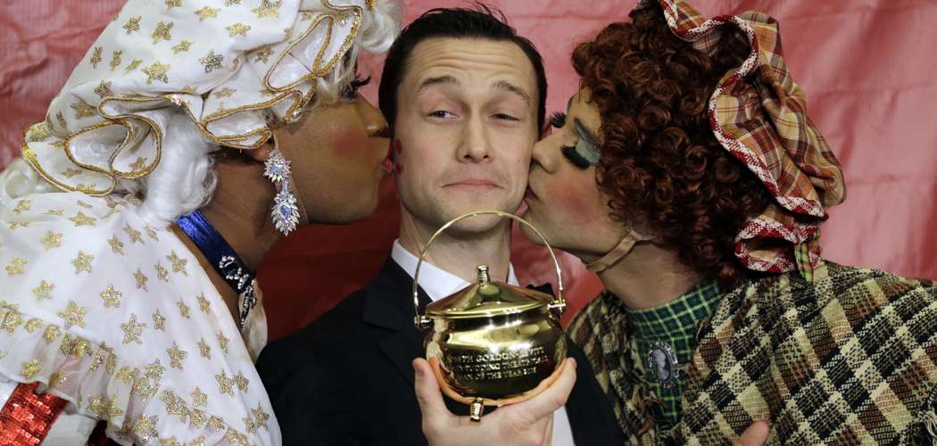 Actor Joseph Gordon-Levitt is kissed by two actors in drag after being awarded the pudding pot as Harvard University's Hasty Pudding Theatricals Man of the Year on Friday, Feb. 5, 2016. (Elise Amendola/AP)