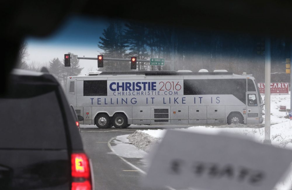 A campaign bus carrying Republican presidential candidate, New Jersey Gov. Chris Christie, passes the motorcade carrying Republican presidential candidate Donald Trump at a crossroad in Windham, N.H., Monday. (Charles Krupa/AP)