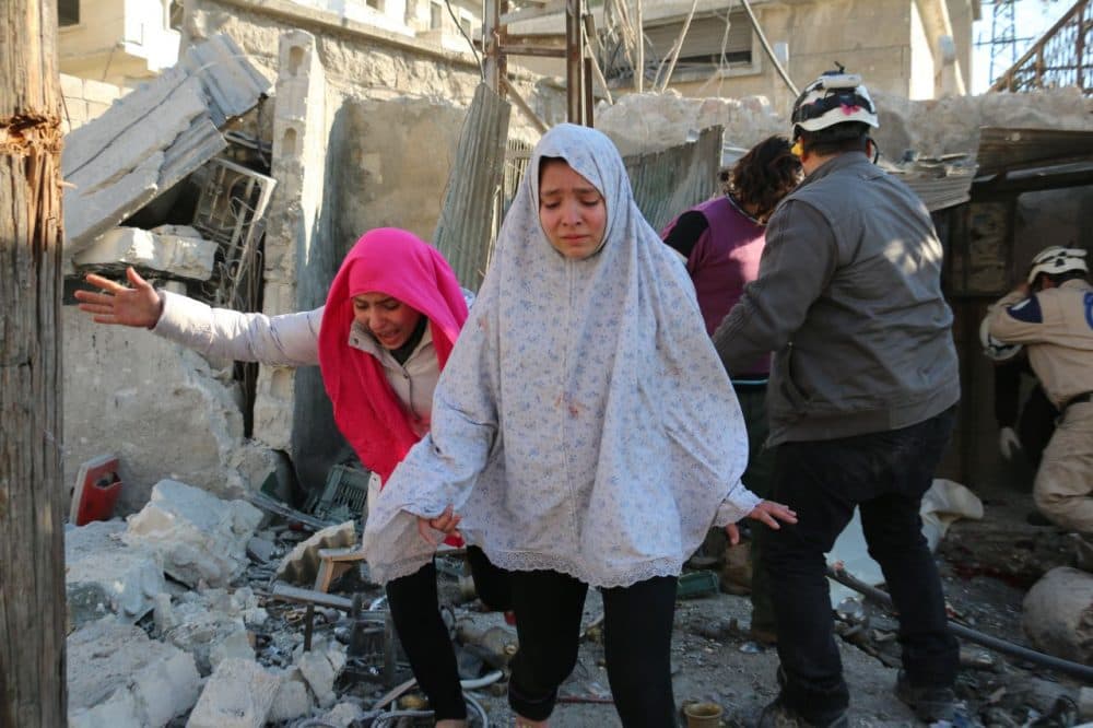 Syrian girls react following a reported Syrian regime air strike in a rebel-controlled area in the northern city of Aleppo on February 8, 2016. Regime forces backed by intense Russian air strikes have closed in on Aleppo city in their most significant advance since Moscow intervened in September in support of President Bashar al-Assad's government. (Ameer al-Halbi/AFP/Getty Images)