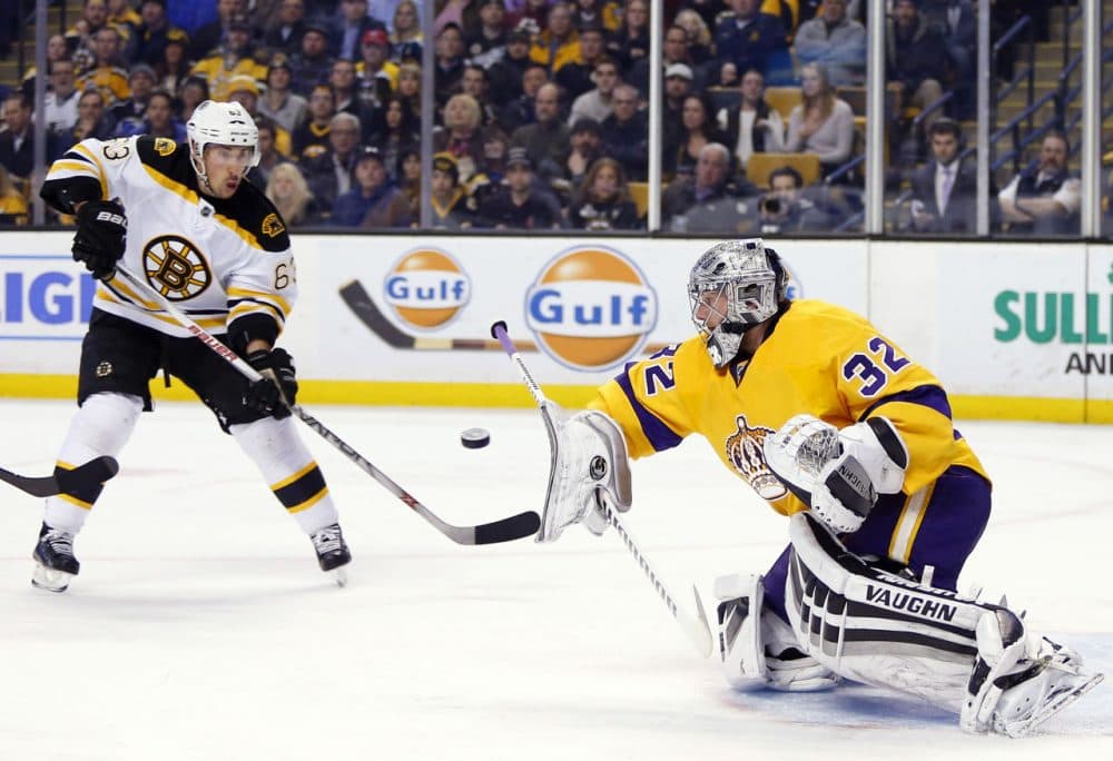 Kings goalie Jonathan Quick makes a blocker save as Bruins' Brad Marchand looks for the rebound during the second period of the game in Boston Tuesday, Feb. 9, 2016. (Winslow Townson/AP)