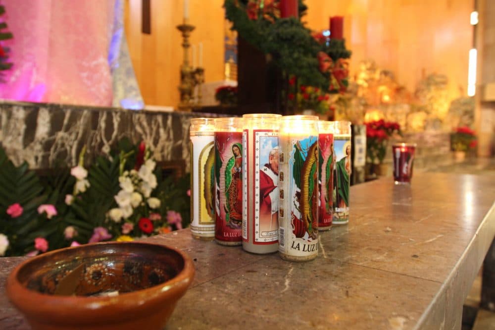 Visitors to the Cathedral of Our Lady of Guadalupe in Juárez place votive candles with the image of Virgen de Guadalupe, Mexico's patron saint, on a platform below the pulpit. Juárez residents interviewed for this story say the Pope's use of his position to promote social change resonates here. (Lorne Matalon)