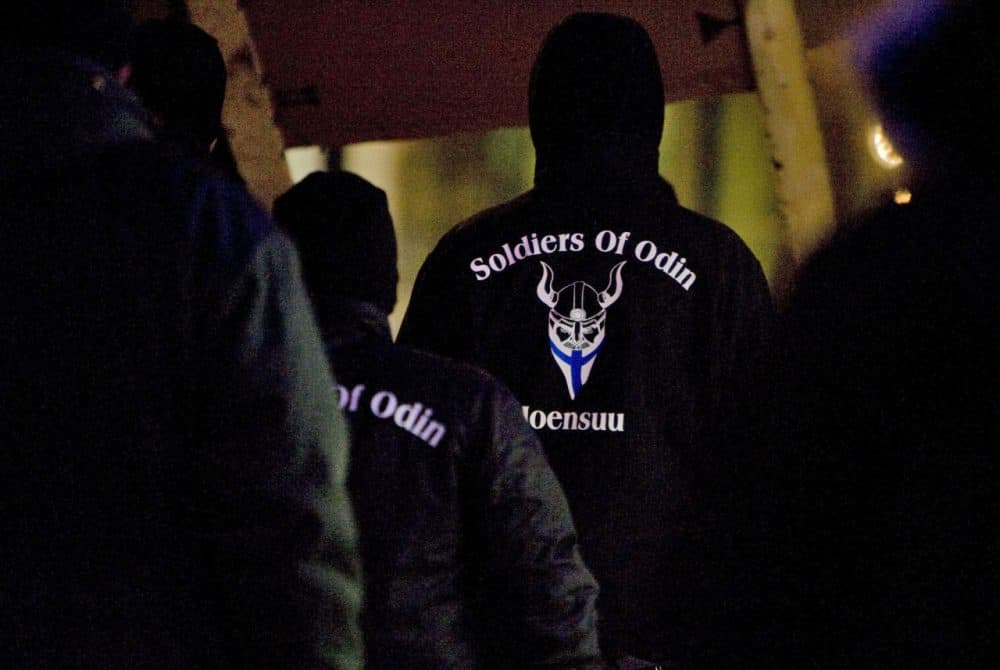 In this photo taken on Friday, Jan. 8, 2016, a group that calls itself the Soldiers of Odin demonstrates in Joensuu, Finland. The rise of the Soldiers of Odin, which claims 500 members, has sparked both concern and ridicule in the Nordic country. They derive their name from a Norse god, and insist their patrols are needed to protect the peace in the sparsely populated nation of 5.5 million, which wasn't a major destination for migrants until 32,500 people applied for asylum last year. The Soldiers are now being challenged by a group of smiling women offering hugs and even some clowns. (Minna Raitavuo/Lehtikuva via AP)
