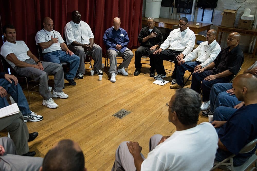 Inmates participate in a group meditation prior to a group discussion  during the Restorative Justice Retreat at the Massachusetts Correctional Institution Norfolk in Norfolk, Massachusetts on June 22, 2014.