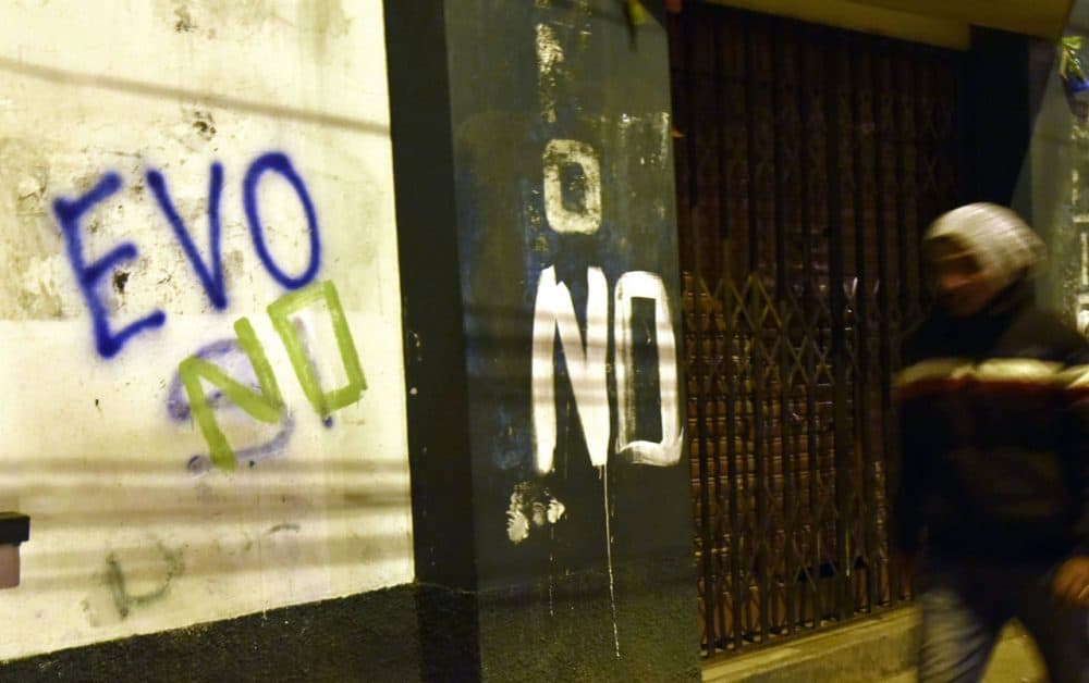 A man is seen walking next to a graffiti that reads &quot;Evo no&quot; after the referendum rejection in El Alto, Bolivia, on February 21. Bolivians on Sunday rejected leftist President Evo Morales' bid to seek a fourth term and potentially extend his presidency until 2025, local media reported. (Aizar Raldes/AFP/Getty Images)