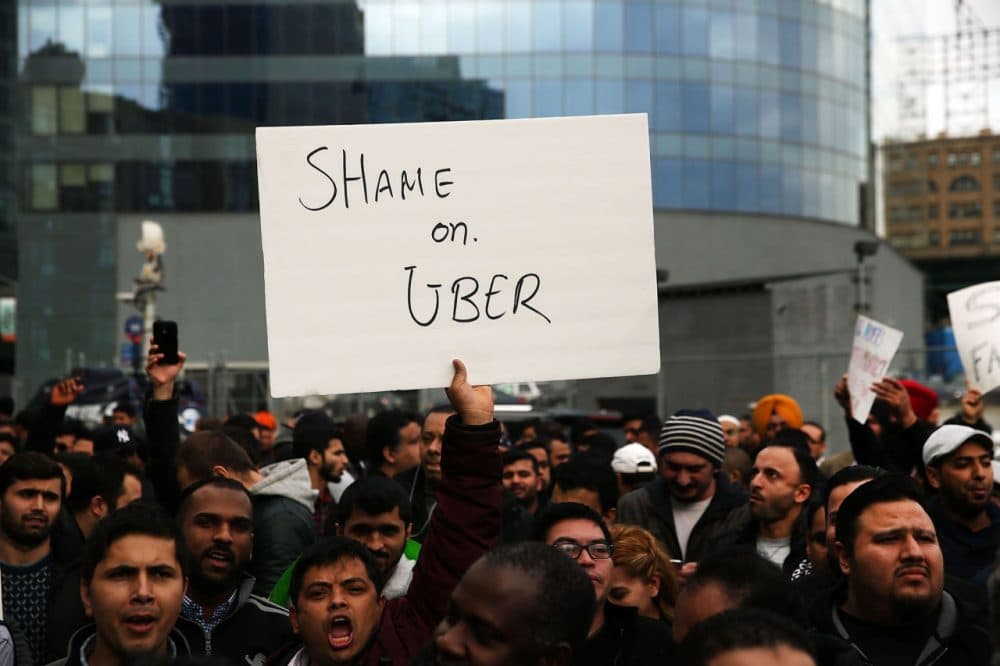 Uber drivers protest  the company's recent fare cuts and go on strike in front of the car service's New York offices on February 1, 2016 in New York City. The drivers say Uber continues to cut into their earnings without cutting into its own take from each ride. In claiming fare reduction would mean more work for drivers, the San Francisco based company cut its prices by 15 percent last week.  (Spencer Platt/Getty Images)