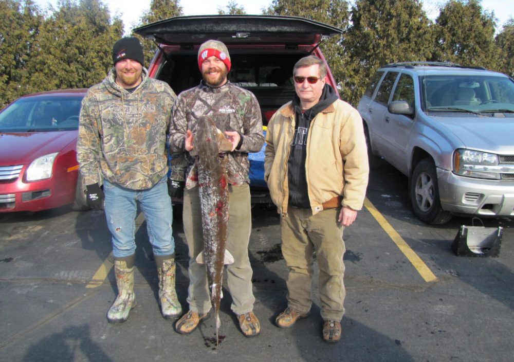 Josh Gumtow, David Schreck &amp; Bill Pahl. Schreck lives in Appleton &amp; speared his first sturgeon opening weekend. His wife said she had the fish &quot;delivered&quot; to his shanty as a Valentine's Day gift. (Susan Bence/WUWM)
