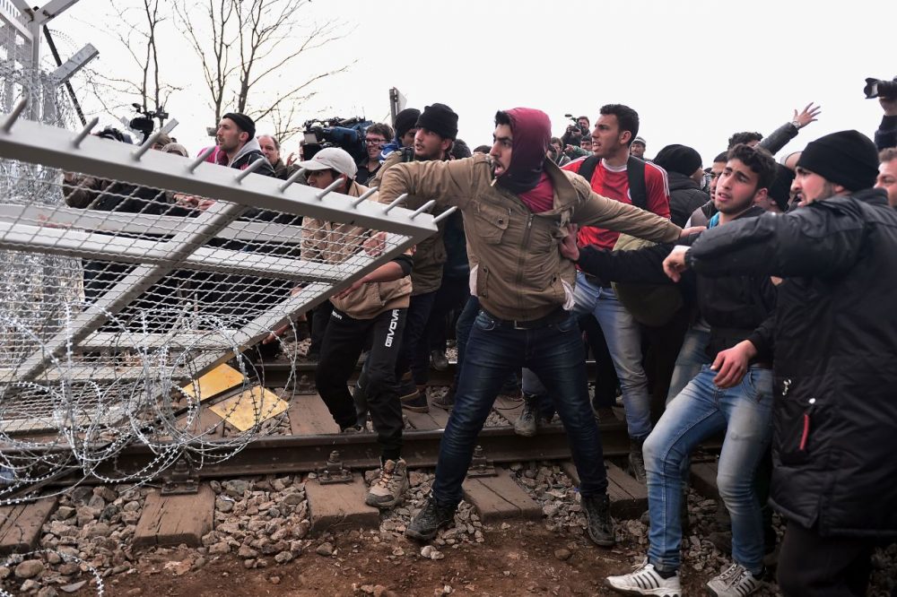 Refugees break into the Greek-Macedonian borders during their protest demanding the opening of the borders near the village of Idomeni on February 29, 2016. 
Macedonian police fired tear gas on February 29, 2016, as a group of some 300 Iraqi and Syrians forced their way through a Greek police cordon and raced towards a railway track between the two countries. With Austria and Balkan states capping the numbers of migrants entering their soil, there has been a swift buildup along the Greece-Macedonia border with Athens warning that the number of people &quot;trapped&quot; could reach up to 70,000 by next month.  (Louisa Gouliamaki/AFP/Getty Images)