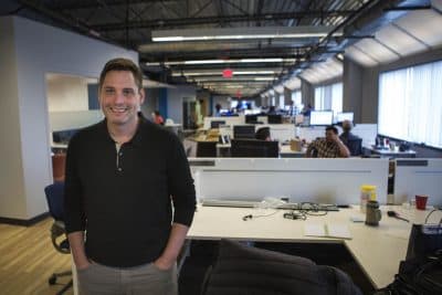 The CEO of Fuze, formerly ThinkingPhones, Steve Kokinos, stands in the company's offices that are rapidly getting too small, thanks to the company's sudden growth. (Jesse Costa/WBUR)