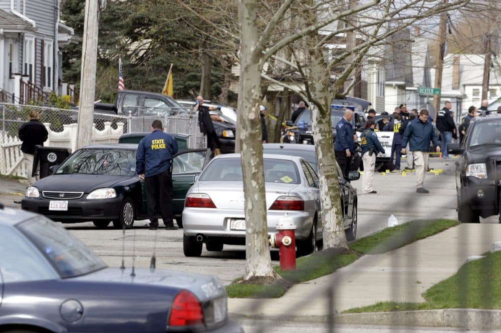The scene in Watertown on April 19, 2013, after the Boston Marathon bombers engaged in a violent gunfight with police on a quiet residential street. One of the suspects was killed, the other escaped before being captured several hours later hiding in a covered boat in a nearby backyard. (Matt Rourke/AP)
