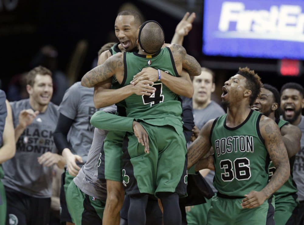 Celtics' Avery Bradley, top, and Isaiah Thomas hug after the Celtics defeated the Cleveland Cavaliers 104-103 in a game Friday in Cleveland. Bradley made a corner jumper at the horn to give the Celtics the win.(Tony Dejak/AP)
