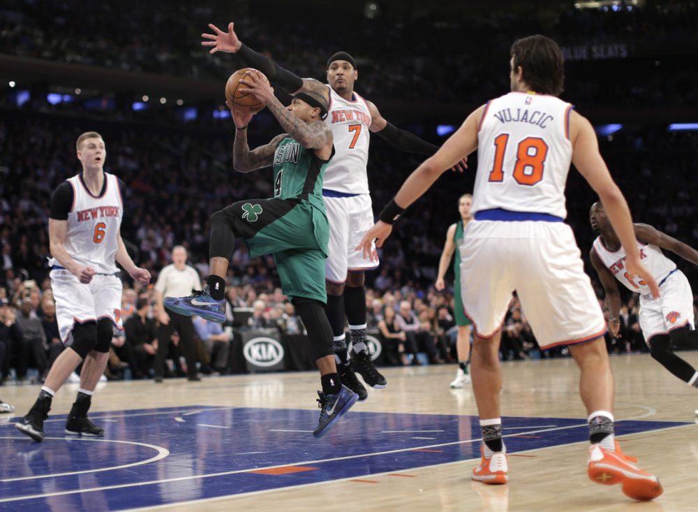 Boston Celtics guard Isaiah Thomas drives through the New York Knicks defense during the third quarter of the game. (Julie Jacobson/AP)