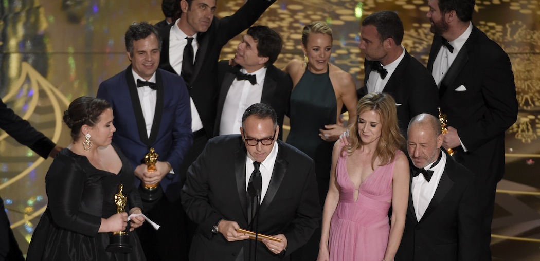 The cast and crew, along with Boston Globe reporter Michael Rezendes (next to Rachel McAdams)  celebrate their Oscar win last night. (Chris Pizzello/Invision/AP)