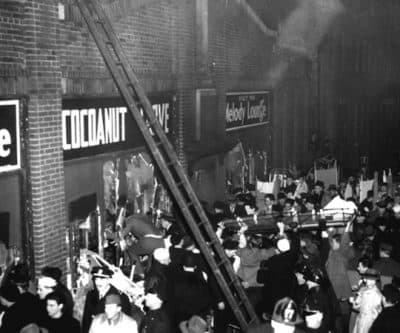 Boston fire and police department workers and many servicemen jam the street outside the Cocoanut Grove nightclub on November 28, 1942. The deadly fire is the subject of a new play.  (AP Photo)