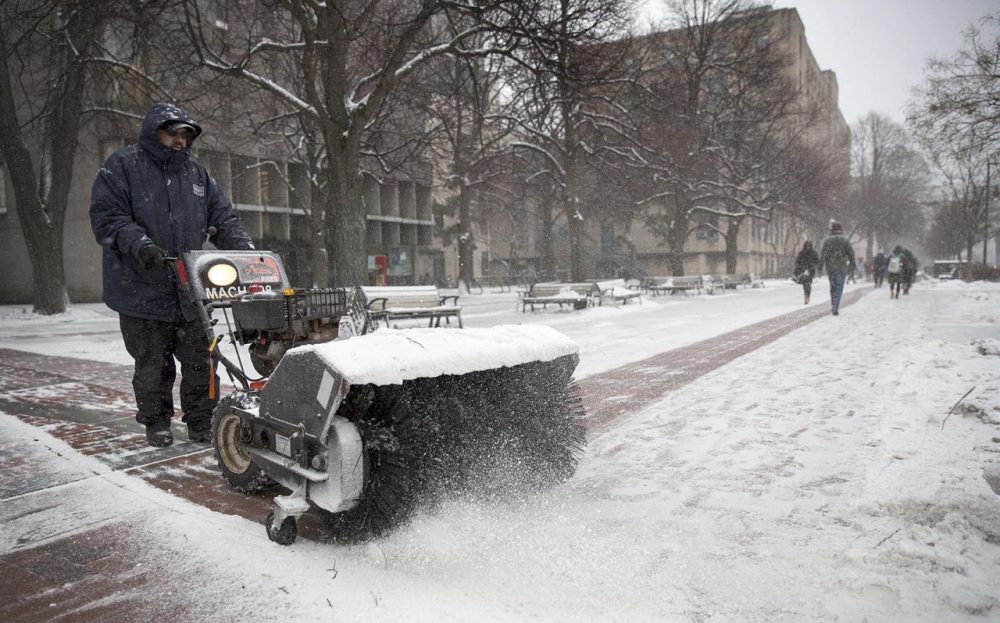 John Moreira clears snow from Monday's storm off sidewalks on Commonwealth Ave. (Robin Lubbock/WBUR)