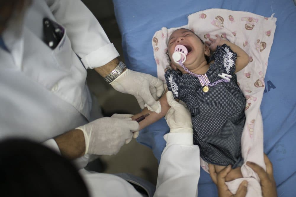 A doctor draw blood from Luana, who was born with microcephaly, at the Oswaldo Cruz Hospital in Recife, Brazil. Brazilian officials believe there's a sharp increase in cases of microcephaly and strongly suspect the Zika virus, which first appeared in the country last year, is to blame.  (AP Photo/Felipe Dana)
