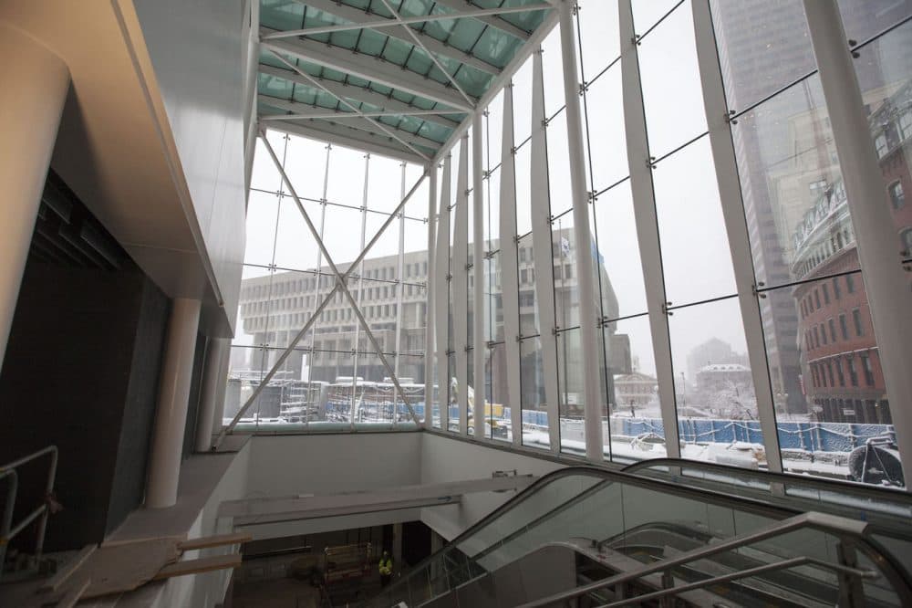 The MBTA's Government Center station reopened Monday after two years of renovations. 
The new station has a 40-foot-high glass entryway (pictured here last month), elevators and remodeled platforms. The project cost $82 million and makes the station accessible for the first time. (Joe Difazio for WBUR)