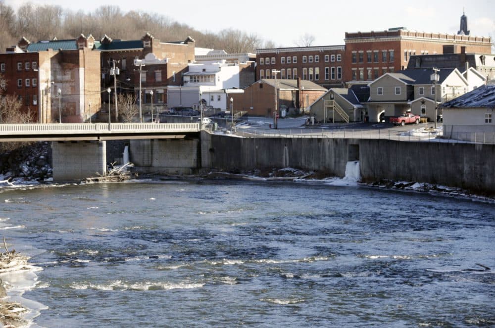 In this Jan. 21, 2016, photo, the Hoosic River runs through the village of Hoosick Falls, N.Y. New York regulators say Saint-Gobain Performance Plastics and Honeywell International are required to pay for the investigation and cleanup of a toxic chemical in the upstate villages drinking water. (Mike Groll/AP)