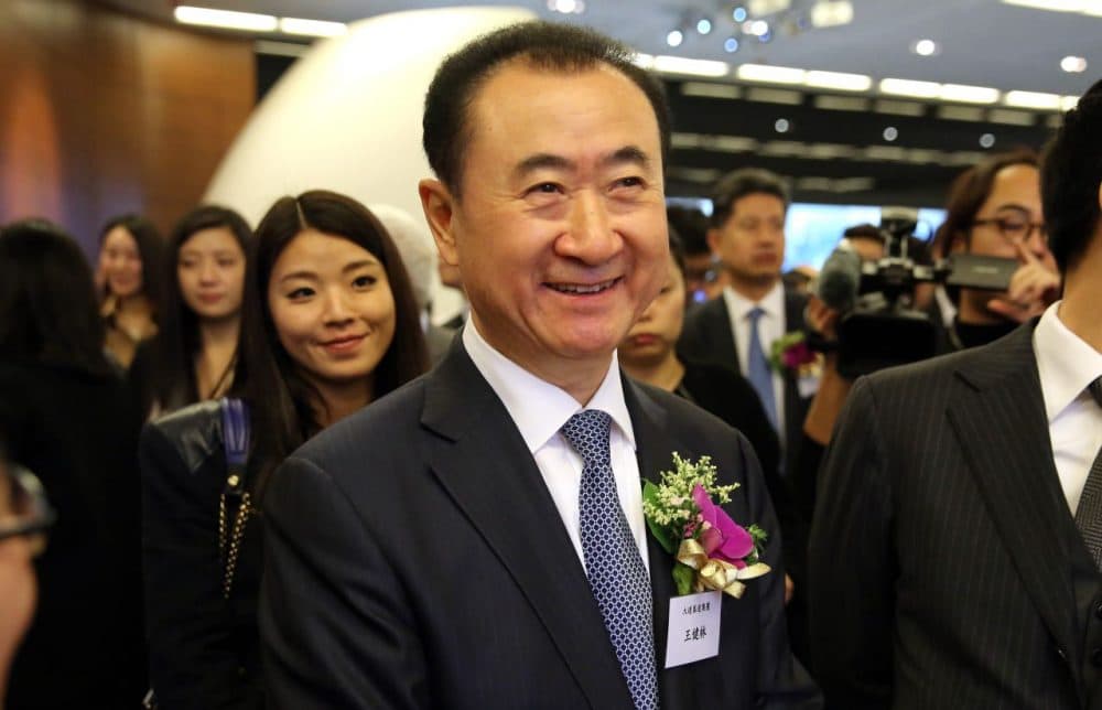 Wang Jianlin (center), CEO of Dalian Wanda Commercial Properties Co Ltd, arrives before the company's IPO at the Hong Kong Stock Exchange in the Central district of Hong Kong on December 23, 2014. Wang Jianlin rose from local bureaucrat to China's richest man by transforming a debt-laden state-owned housebuilder into the sprawling Wanda Group, and the flotation of one of its subsidiaries on December 23 may propel him back up a rich list now dominated by Internet moguls. (Isaac Lawrence/AFP/Getty Images)