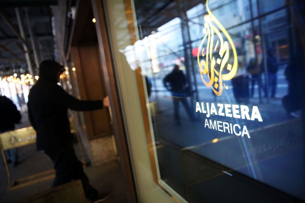 The logo for Al Jazeera America is displayed outside of the cable news channel's offices on January 13, 2016 in New York City. Al Jazeera America, which debuted in August 2013,  announced today that they are shutting down. Employees of the struggling news network known as AJAM were informed of the decision during an all-hands staff meeting on Wednesday afternoon.  (Spencer Platt/Getty Images)