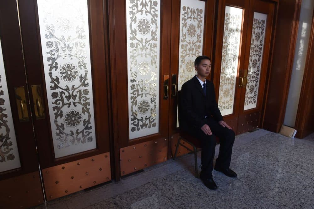 A security guard sits near a set of doors during delegation meetings at the National People's Congress in Beijing's Great Hall of the People on March 7, 2016.
China's Communist-controlled parliament opened on March 5 to approve a new five-year plan to tackle slowing growth in the world's second-largest economy. (GREG BAKER/AFP/Getty Images)