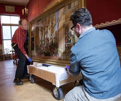 Art handler John Peitso, left, and collections care associate Matthew Del Grosso carefully load Botticelli's &quot;The Tragedy of Lucretia&quot; onto a cart for its short journey to the new building at the Isabella Stewart Gardner Museum for an upcoming exhibition. (Robin Lubbock/WBUR)