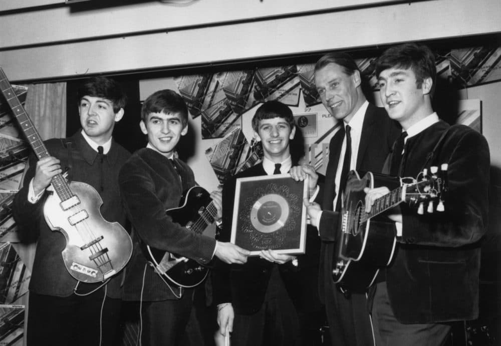 The Beatles hold their silver disc for sales of more than 250,000 copies of their debut studio album “Please, Please Me” on April 8, 1963. Left to right are, Paul McCartney, George Harrison (1943 - 2001), Ringo Starr, George Martin of EMI and John Lennon (1940 - 1980). (Chris Ware/Keystone/Getty Images)
