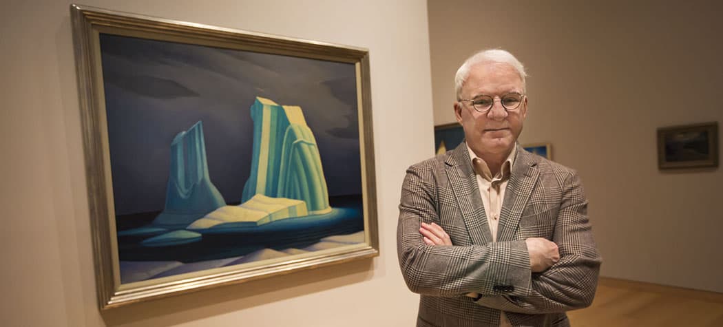 Steve Martin is curating a new show about Canadian modernist painter Lawren Harris. Here, Martin stands in front of Harris' &quot;Icebergs,&quot; on display at the Museum of Fine Arts in Boston. (Jesse Costa/WBUR)