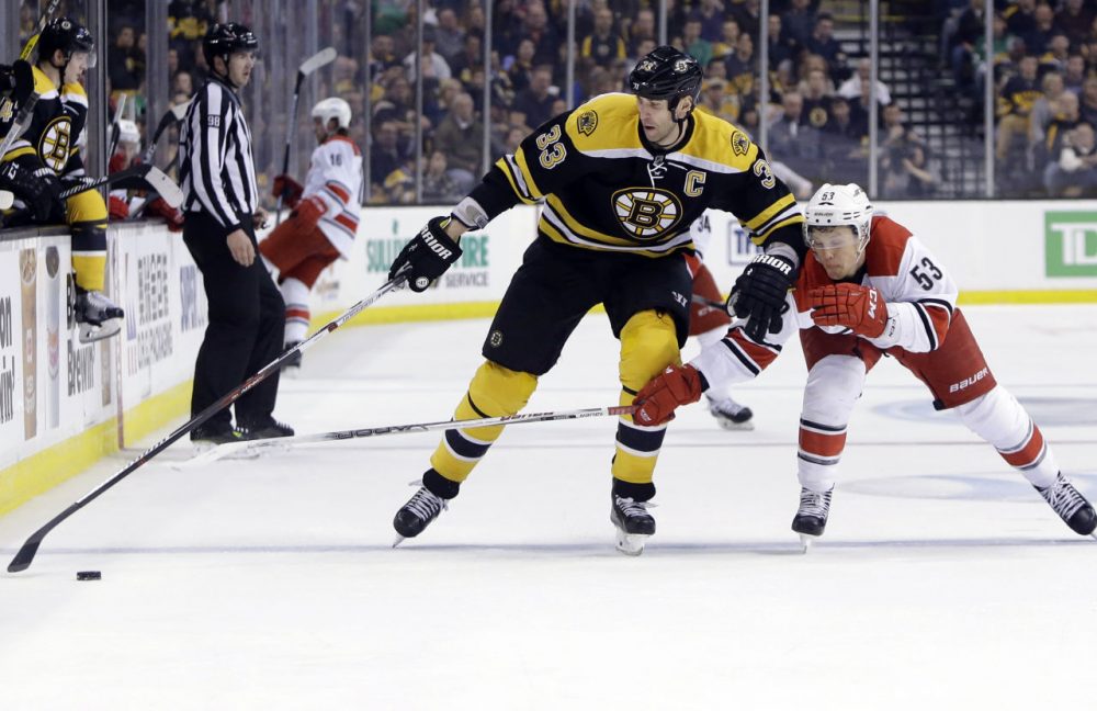 Bruins defenseman Zdeno Chara keeps the puck away from Hurricanes left wing Jeff Skinner a game at the Garden, Thursday, March 10, 2016, in Boston. (Elise Amendola/AP)