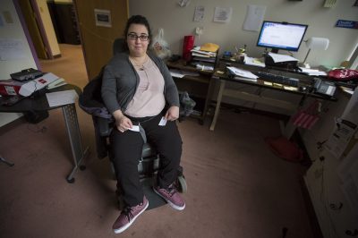 Sarah Kaplan was born with cerebral palsy and is in a power wheelchair. The 32-year-old relies on The Ride to get around, including from her apartment in Lynn to her office in Boston. (Jesse Costa/WBUR)