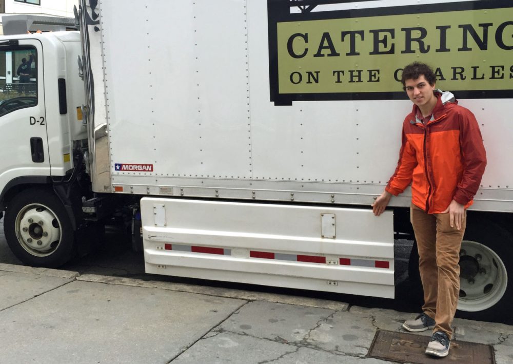 Dustin Weigl stands next to a Catering on the Charles truck that features side guards aimed at preventing cyclists or pedestrians from being pulled under the truck. Weigl is pushing to get the guards on all trucks. (Robin Young/Here &amp; Now)