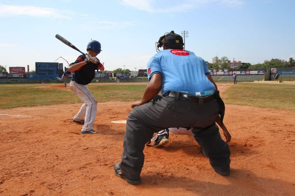 A prospects game at Estadio Tomás Arrieta, home of the Édgar Rentería Baseball Academy in Barranquilla on Colombia’s Caribbean coast. Some players here said they dream of a pro career in the U.S. Others said they want to use their talent to get a U.S. college scholarship. (Lorne Matalon)