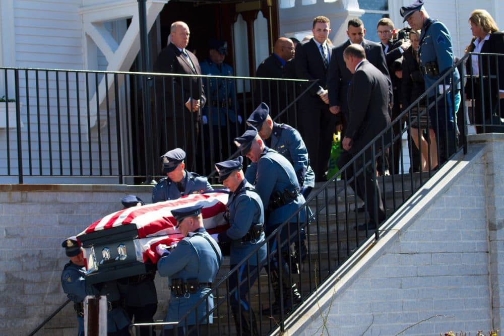 State troopers carry Trooper Thomas Clardy’s casket down the steps of St. Michael’s Church in Hudson on Tuesday. (Hadley Green for WBUR)