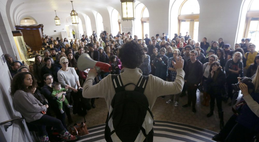 Students, faculty and supporters listen to a speaker during a rally protesting a series of tuition increases at the  University of California, Berkeley, Tuesday, Dec. 2, 2014. (Jeff Chiu/AP)